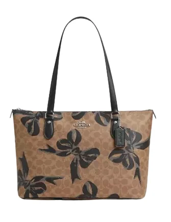 Ladies Coach Tabby bags with a textured leather surface for a more tactile lookCoach Gallery Tote Bag In Signature Canvas With Bow Print